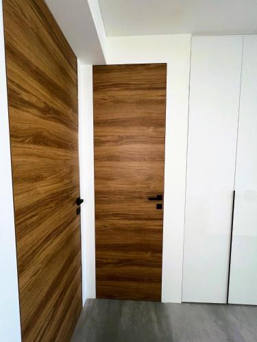 a wooden door in a room at Pri jazere - Golf rezort in Hrubá Borša