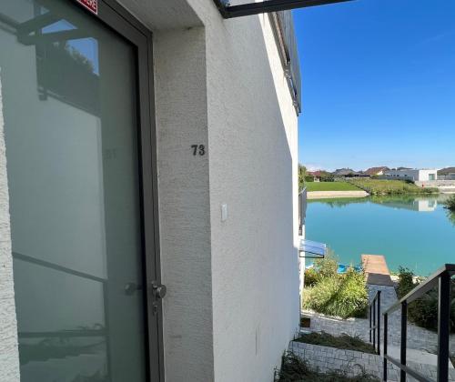 a door to a building with a view of a body of water at Pri jazere - Golf rezort in Hrubá Borša