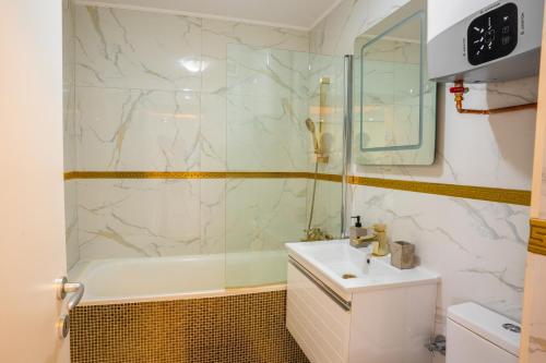 a bathroom with a tub and a sink and a shower at Quiet Marble Apt with Free Parking Spot Old Town in Bucharest