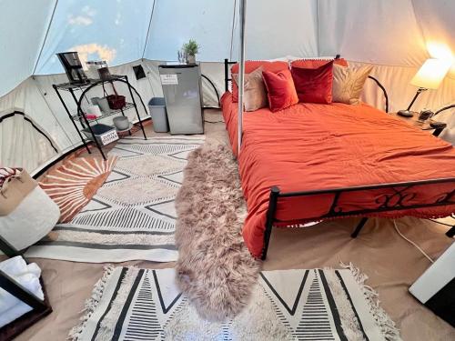 a bedroom with a bed in a tent at The Juniper Ranch and Retreat in Canyon Lake