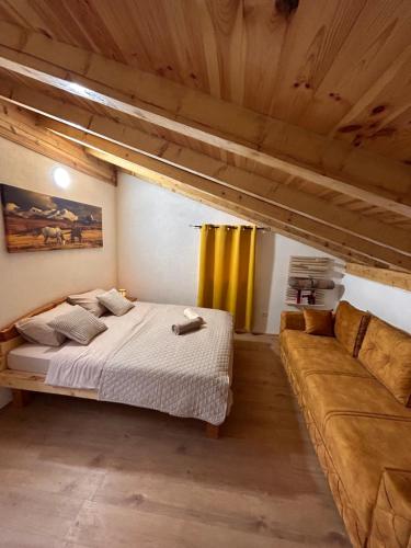a bedroom with a bed and a couch at Apartments Javorje Zabljak in Žabljak