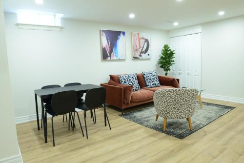a living room with a couch and a table and chairs at Spacious 2-Bed-Room near Yonge & Major Mackenzie in Richmond Hill