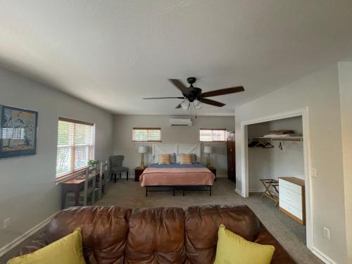 a living room with a couch and a ceiling fan at Goldsmith's River Front Inn in Missoula