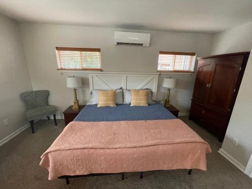 1 dormitorio con 1 cama grande y 2 ventanas en Goldsmith's River Front Inn, en Missoula