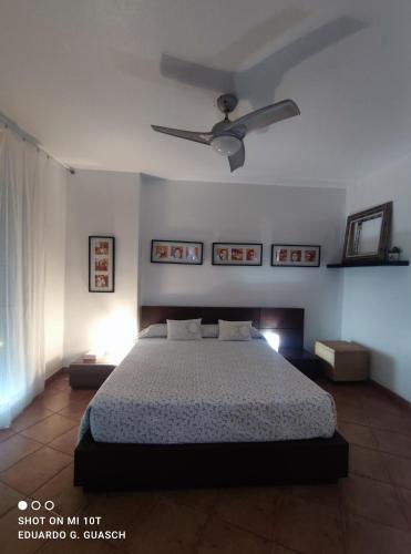 a bedroom with a bed and a ceiling fan at Disfruta Águilas in Águilas