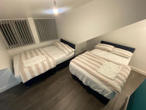 two beds in a small room with at ENTIRE MODERN HOUSE in Elland