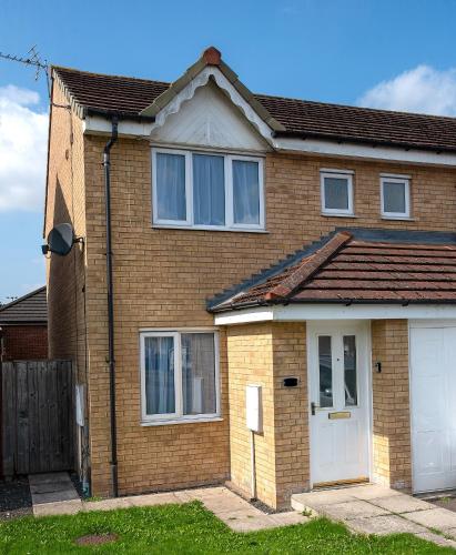 a brick house with a white garage at Witton House in Stockton-on-Tees