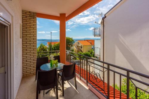 a balcony with a table and chairs and a view at Apartmani Višnja in Crikvenica