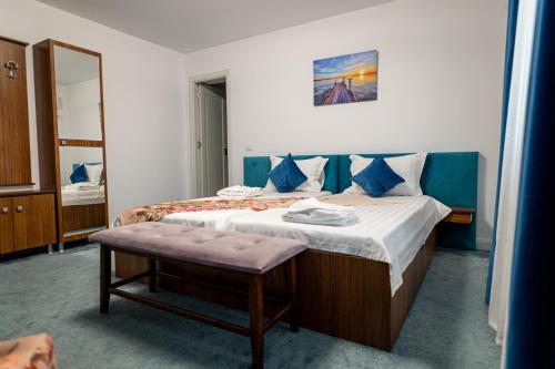 a bedroom with a large bed with a mirror at Sole Boutique in Râmnicu Vâlcea