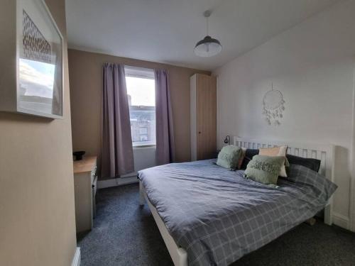 a bedroom with a bed and a window at Home from Home Liverpool - Entire Home in Liverpool