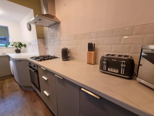 a kitchen with a counter with a toaster on it at Home from Home Liverpool - Entire Home in Liverpool