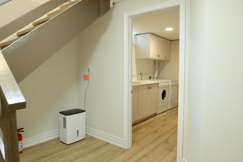 an open hallway leading to a kitchen with a staircase at Spacious 2-Bed-Room near Yonge & Major Mackenzie in Richmond Hill