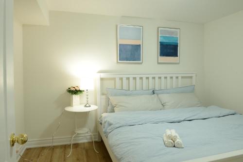 a bed with a pair of white shoes on it at Spacious 2-Bed-Room near Yonge & Major Mackenzie in Richmond Hill