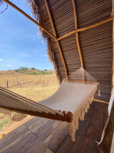 a hammock hanging from a thatched roof at La Chantin in Pedregal
