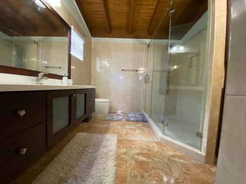 a bathroom with a glass shower and a sink at Portmore - Cheerful Private Bedroom with Fan only or AC - Choose your room in Portmore