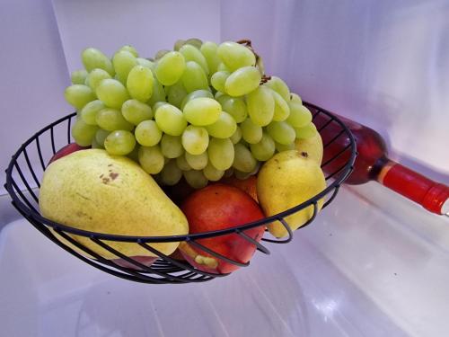 a basket of fruit with grapes and pears at Villa Erofili Plakias south Rethimno Crete in Asómatoi