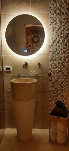 a bathroom with a sink and a mirror at Dimora Cleó in Putignano