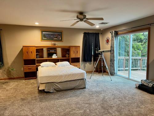 a bedroom with two beds and a ceiling fan at Mountain house in Palmerton