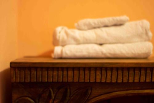a pile of towels sitting on top of a wooden table at Casa Esperanza in Panajachel
