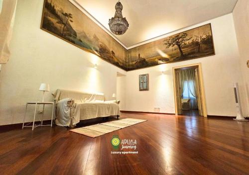 a living room with a bed and a wooden floor at Apulia Journey - Manzoni 11 in Bari