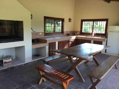 a kitchen with a wooden table and a bench at La Casita en La Juni in San Javier