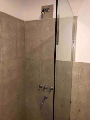 a shower with a glass door in a bathroom at La Casita en La Juni in San Javier