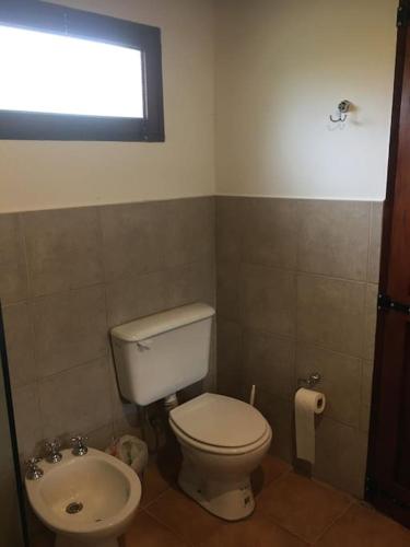 a bathroom with a toilet and a sink at La Casita en La Juni in San Javier