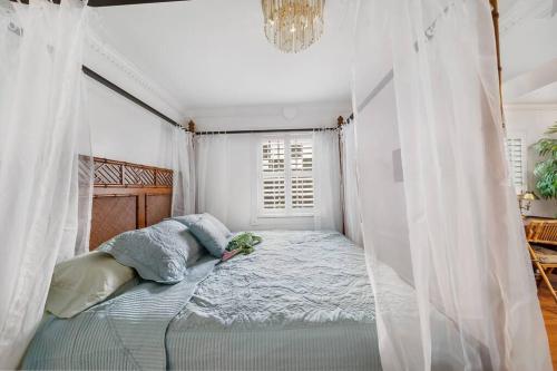 a bedroom with a bed with a mosquito net at The Golden Alligator 2 - 3 beds 1 bath Palm Beach Regency style, near everything in West Palm Beach