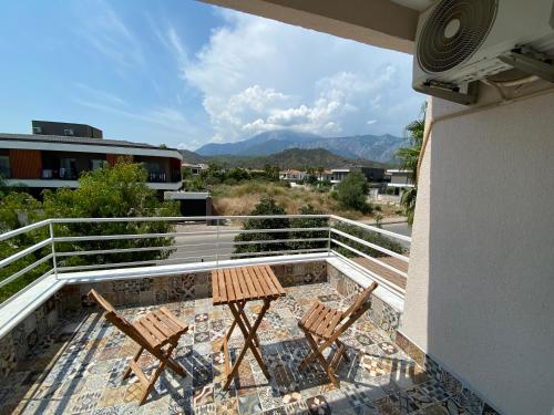 a balcony with two chairs and a table at Orange&Lemon Villas Çamyuva in Kemer