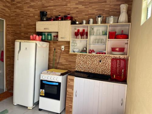 a kitchen with a refrigerator and a stove at Cantinho Casa Grande in Beberibe