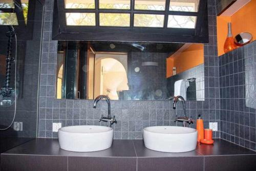 a bathroom with two sinks and a mirror at Aurora Mari Villa Your Dream Steps from the Ocean Shore in Caleta De Fuste