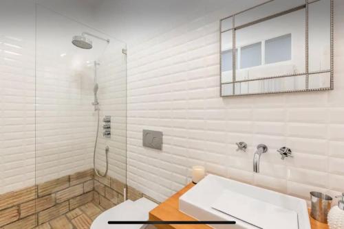 a bathroom with a sink and a shower at Traditional townhouse with private patio and pool in Portimão