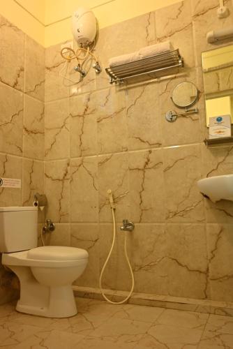 a bathroom with a toilet and a shower at Andaman Galley Boutique Hotel in Port Blair