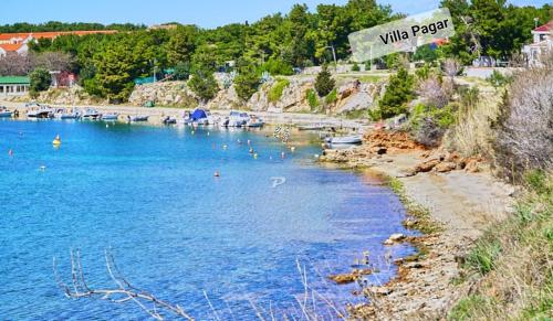a view of a body of water with boats in it at Villa Pagar - with jacuzzi - Renovated in 2022 in Povljana