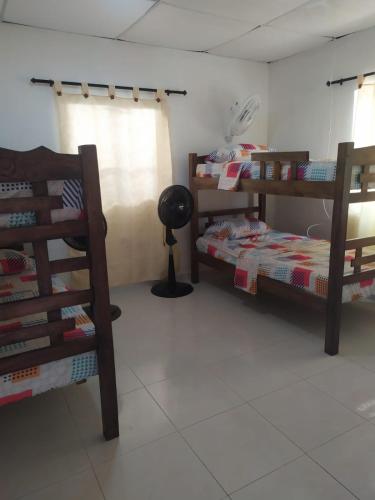 a room with two bunk beds and a lamp at Casa Caribe in Santa Marta