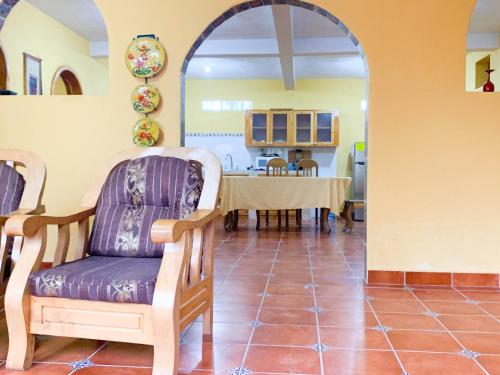 a living room with a table and a chair at Casa Esperanza in Panajachel