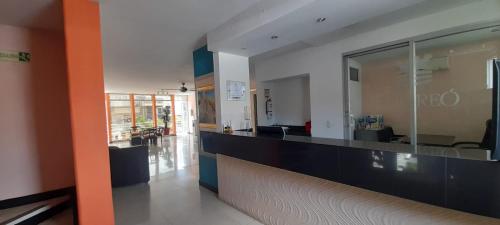 a lobby with a long counter in a building at HOTEL TORREON AV in Neiva