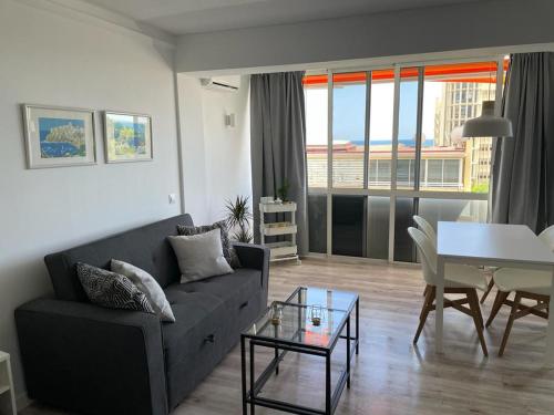 a living room with a couch and a table at Apartamento C y L in Torremolinos