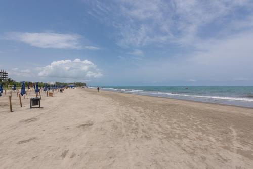 a group of people walking on the beach at Lujoso Apartamento Con Salida Directa A La Playa Edificio Morros Eco in Cartagena de Indias