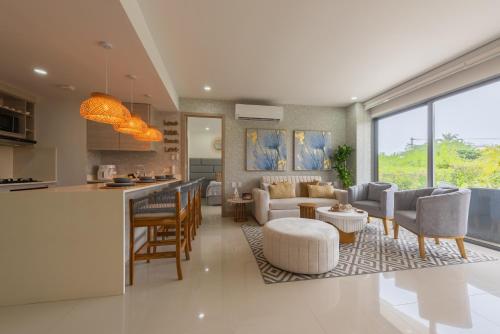 a kitchen and living room with a couch and a table at Lujoso Apartamento Con Salida Directa A La Playa Edificio Morros Eco in Cartagena de Indias
