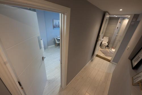 a hallway with a door leading to a bathroom at Central Brighton modern one bed apartments in Brighton & Hove