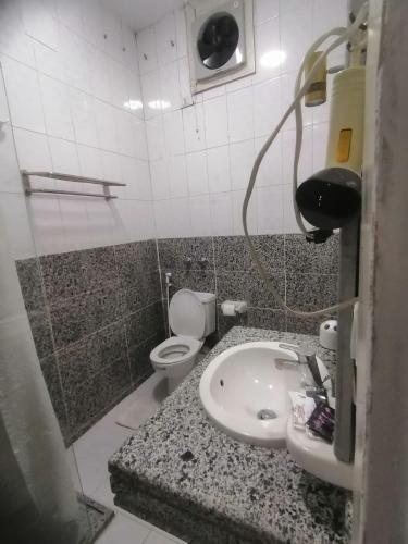 a bathroom with a sink and a toilet at Rezeiky Hotel & Camp in Luxor