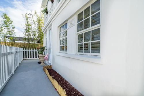 a white building with a window on the side of it at The Golden Alligator 1 - 3 beds 2 baths in West Palm Beach close to everything in West Palm Beach