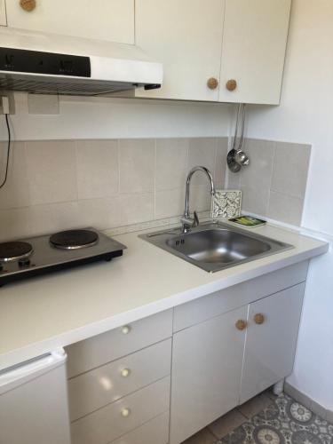 a white kitchen with a sink and a stove at Masseria Sant'Elia Castellaneta in Castellaneta