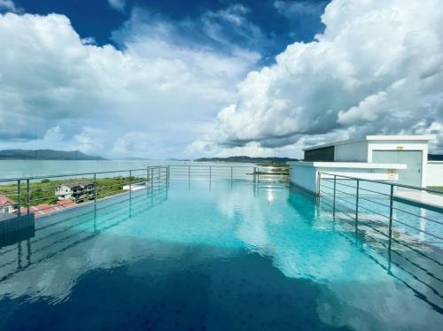 a swimming pool on the roof of a building with water at Bayu Apartment Services in Kuah