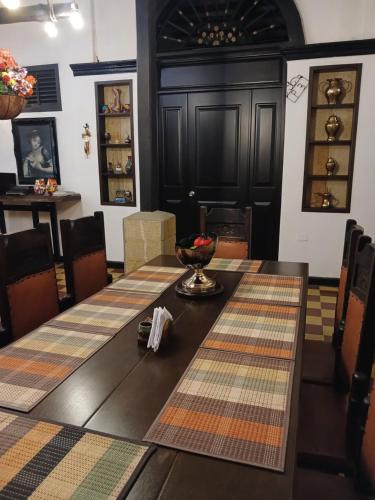 a dining room with a table with a bowl on it at Hotel Boutique Casa Antigua in San Vicente de Chucurí