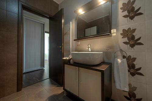 a bathroom with a sink and a mirror at Samali Residence in Eforie Nord