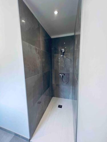 La salle de bains est pourvue d'une douche et d'une paroi en verre. dans l'établissement Magnifique Appartement traversant avec vue sur le golf, à La Grande Motte