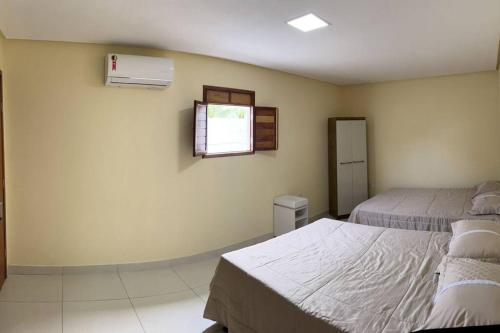 Кровать или кровати в номере Casa de Férias Tabatinga 2