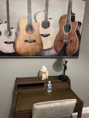 a group of acoustic guitars hanging on a wall at 3 bed rooms Vip family house in Dublin